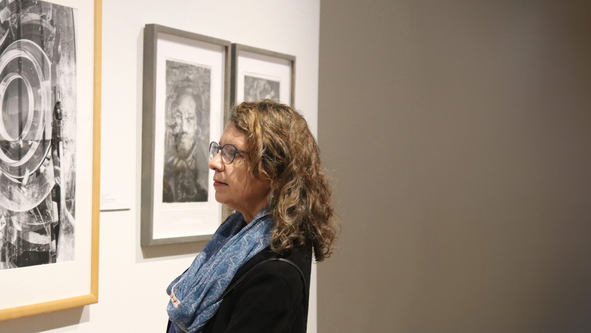 Woman looking at framed artwork