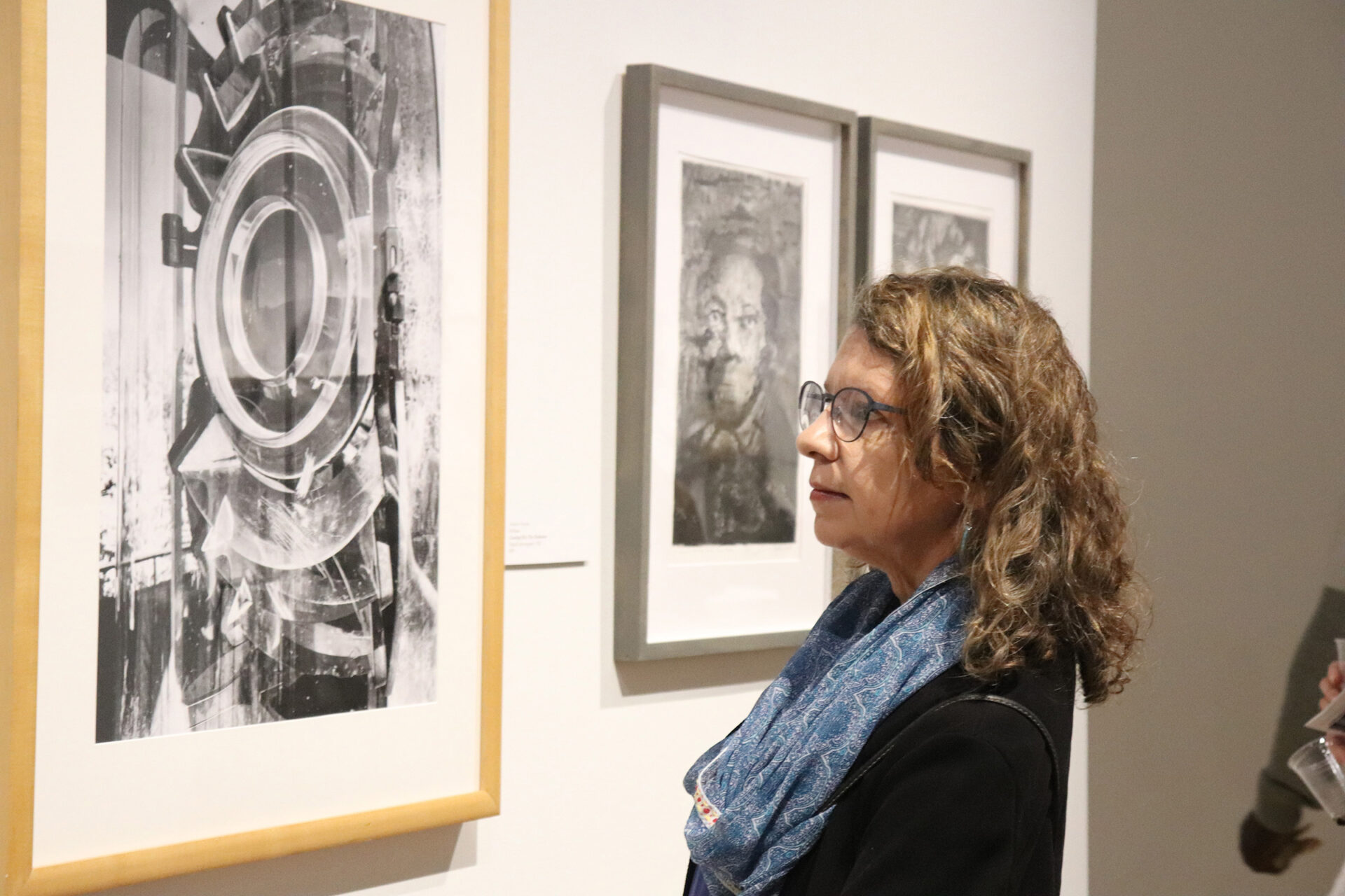 Woman looking at framed artwork