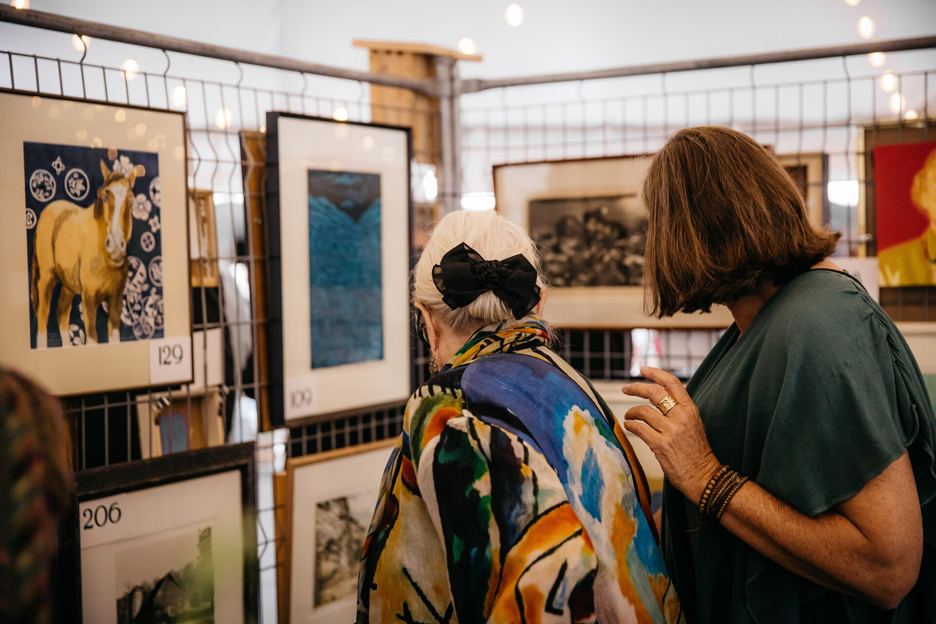 Women looking at artwork for sale